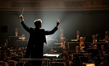 pngtree-conductor-leading-an-orchestra-in-a-dramatic-performance-image_20408277.webp